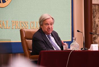 UN Secretary-General António Guterres speaks at a podium during an event at the National Press Club in Japan.