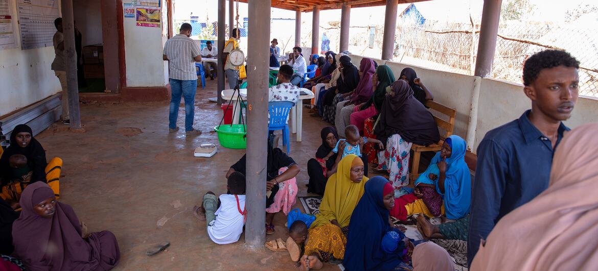 Displaced families, including women and children, wait at the Baxnaano Health Centre in a settlement in Somalia.