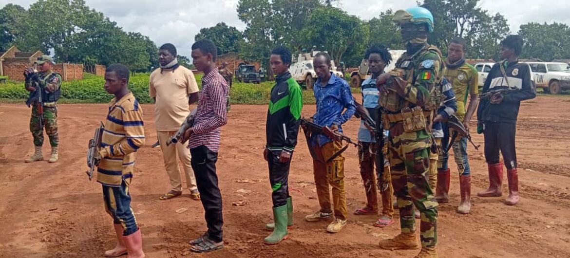 Des Casques bleus sénégalais de la Force de réaction rapide de la MINUSCA se tiennent aux côtés d'un groupe d'hommes armés en République centrafricaine.