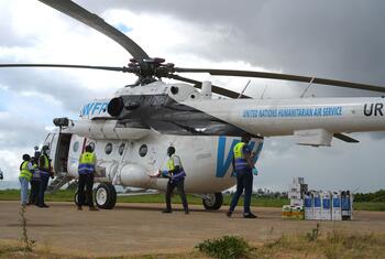 Relief workers load supplies onto a United Nations Humanitarian Air Service helicopter at a field site in the Democratic Republic of Congo.