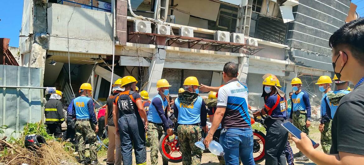 Bureau of Fire Protection personnel inspect earthquake-damaged buildings in Koronadal City, Philippines.