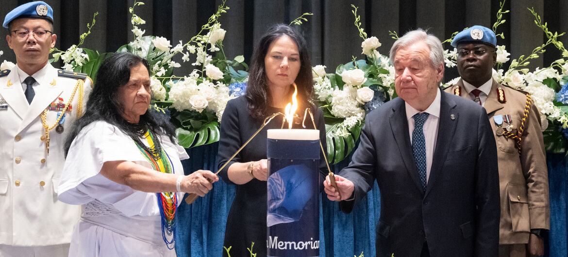 El secretario general de la ONU, António Guterres, y la presidenta de la Asamblea General, Annalena Baerbock, encienden una vela en una ceremonia conmemorativa en honor al personal de las ONU .