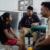 A doctor consults with a young girl and her father in a clinic in India, as part of a UNICEF diabetes treatment program.