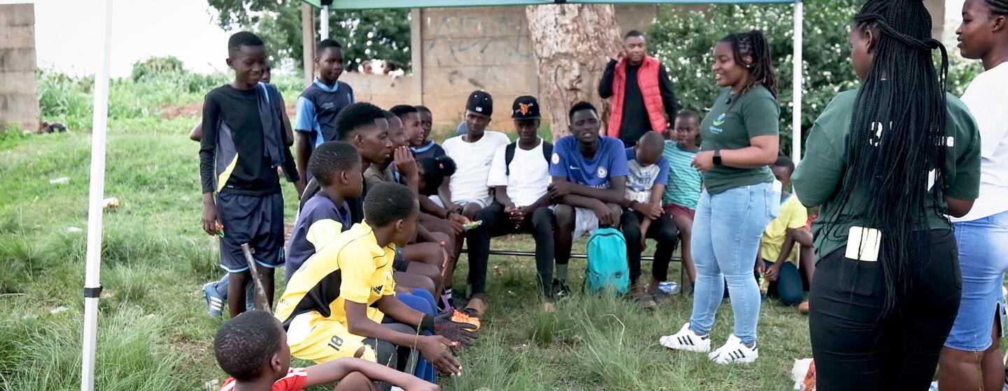 Ndinewe Foundation staff and youth participants in an outdoor community session in Zimbabwe.
