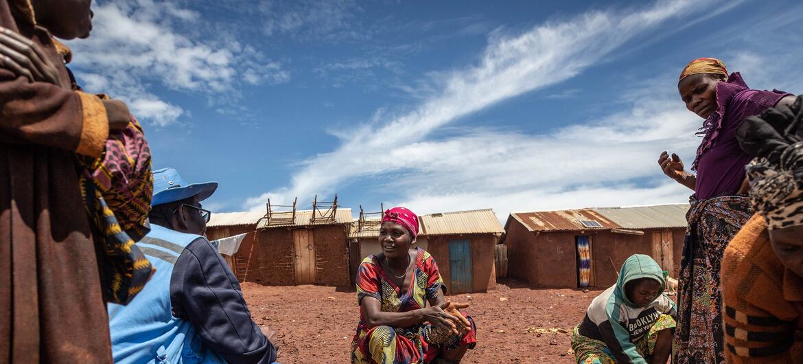 Des femmes et des enfants participent à des activités quotidiennes au camp de personnes déplacées RHOE à Ituri, en RDC.