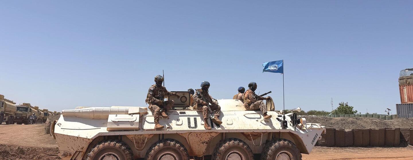 Des soldats de la paix mongols de la MINUSS circulent à bord d'un véhicule blindé de transport de troupes blanc à Bentiu, dans le Haut-Nil.