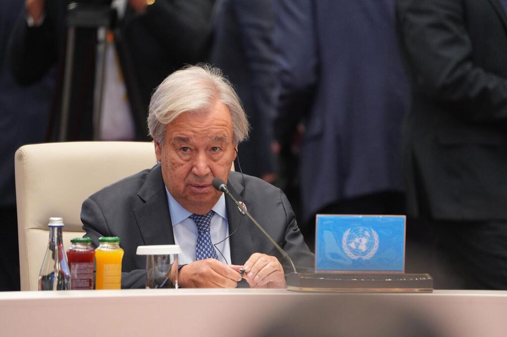 Katibu Mkuu UN António Guterres akizungumza kwenye kipaza sauti katika mkutano wa kilele wa Shirika la Ushirikiano la Shanghai huko Bishkek, Kyrgyzstan, akiwa na bango la bluu la nembo UMOJA WA MATAIFA mezani mbele yake.
