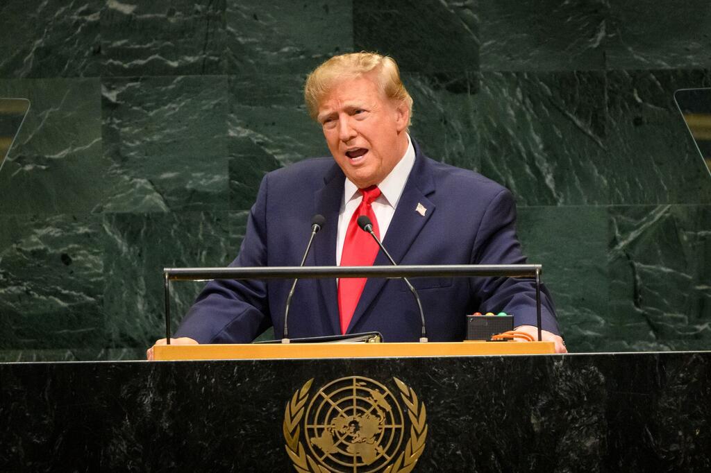 Rais Donald Trump wa Marekani akizungumza kwenye jukwaa lenye maikrofoni mbele ya ukuta wa marumaru ya kijani.