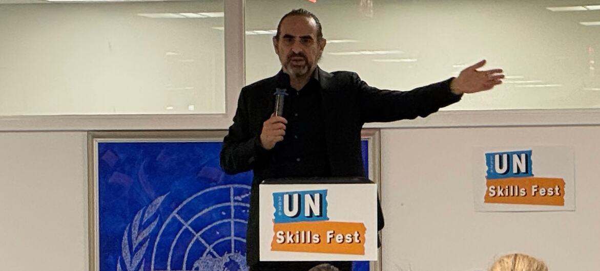 Dr. David Rock speaks to a seated audience at a UN Skills Fest session, standing behind a podium with the UN logo and gesturing with one hand.