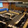 An overhead view of a large conference room at the United Nations, with delegates seated around a curved table during an ECOSOC meeting.
