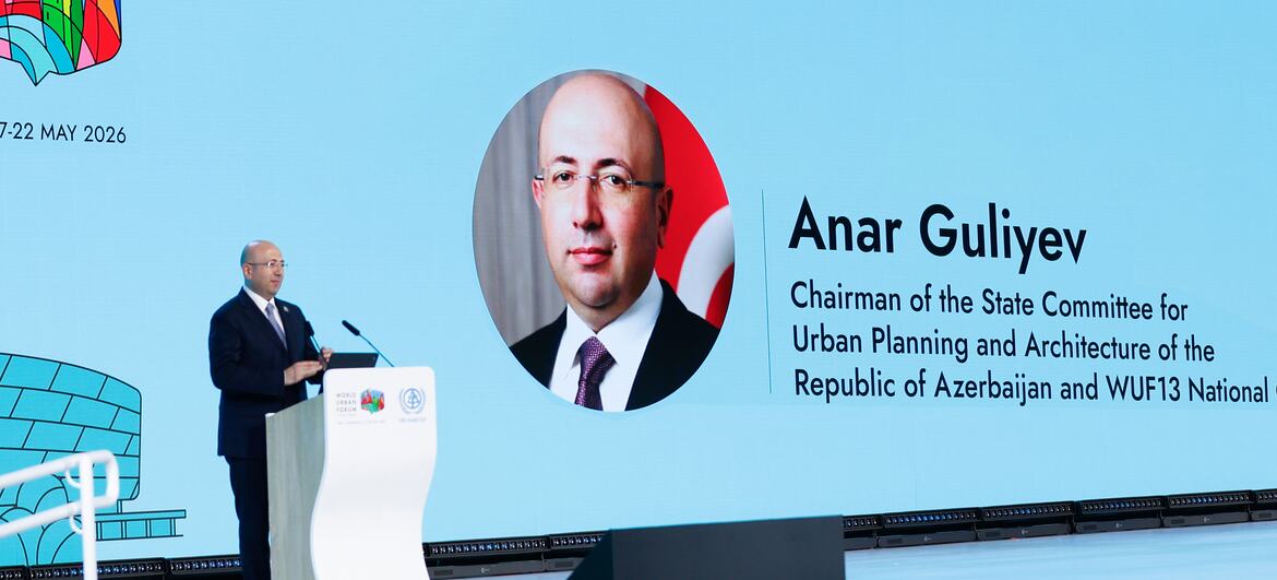 Anar Guliyev speaks at a podium during the World Urban Forum in Baku, Azerbaijan.