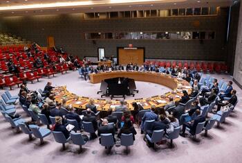 Wide view of the UN Security Council chamber during a meeting on the maintenance of peace and security of Ukraine, showing delegates seated around the large circular table.