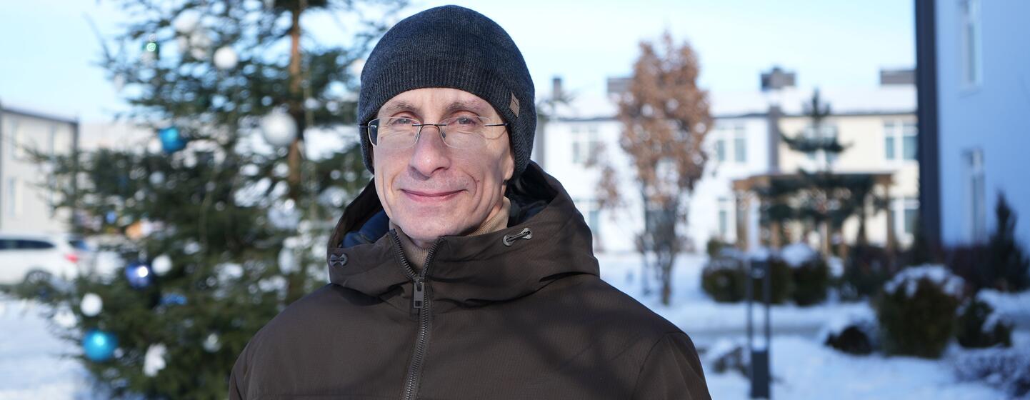 Yurii Shapovalov stands outside a dormitory for displaced people in a suburb of Kyiv, where he is rebuilding his life after years in captivity.