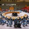 A wide view of the United Nations Security Council meeting on threats to international peace and security, with delegates seated around a large oval table.