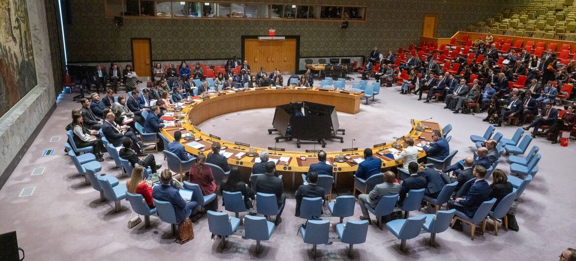 Wide view of the UN Security Council meeting focused on maintaining peace and security in Ukraine, with delegates seated around a large circular table.