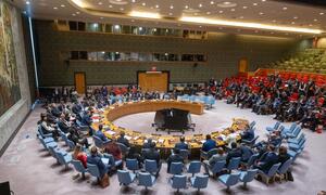 Wide view of the UN Security Council meeting focused on maintaining peace and security in Ukraine, with delegates seated around a large circular table.