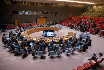 Wide view of the United Nations Security Council chamber during a debate on reaffirming the international rule of law, with delegates seated around a large circular table.