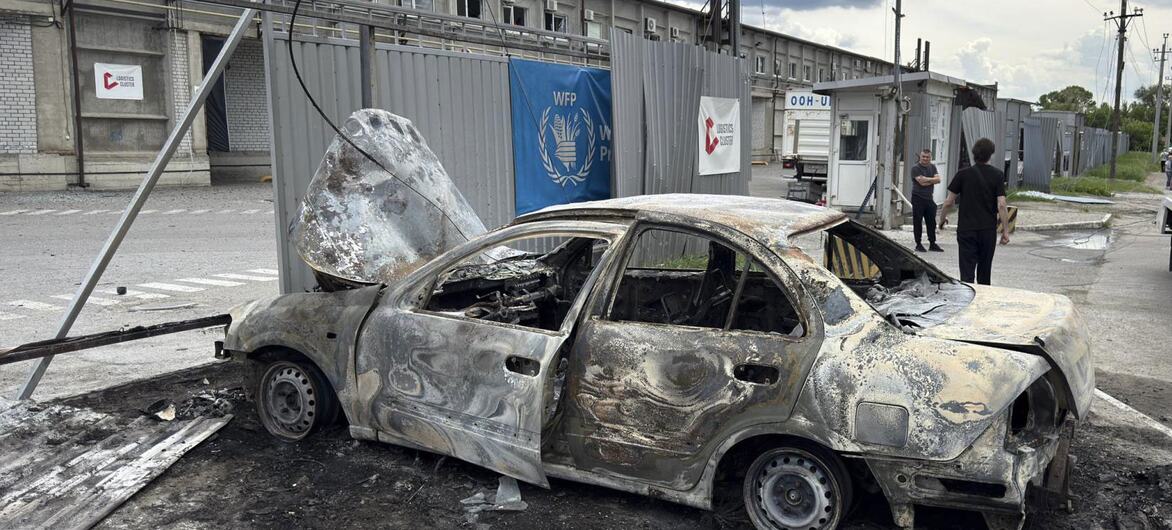 Burnt-out car in front of a damaged WFP facility in Dnipro, Ukraine.