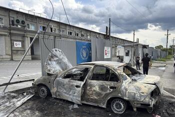 Burnt-out car in front of a damaged WFP facility in Dnipro, Ukraine.