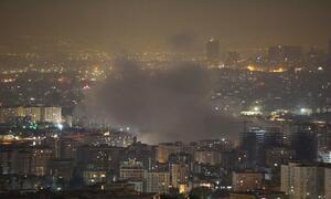 A nighttime cityscape of Tehran, Iran, with smoke rising from a fire in the urban area.  The army of Israel attacked parts of Tehran at dawn on Friday, June 13, 2025.