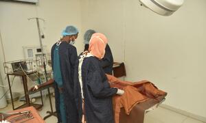 Doctors perform a cesarean section at El Obeid Maternity Hospital in Sudan. The hospital faces equipment shortages, with only 4 of 7 operating rooms functional and limited anesthesia capacity, leading to maternal deaths.