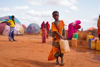 فتاة صغيرة تحمل الماء في مخيم للنازحين في دولو بالصومال.