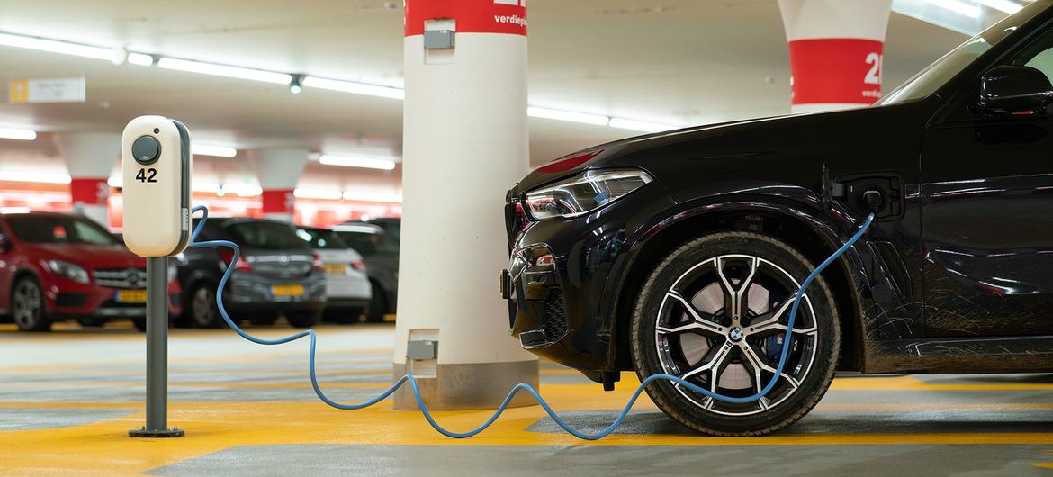 An electric vehicle at charges in a garage.