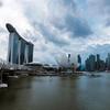 View of the Singapore skyline featuring the Marina Bay Sands hotel, Helix Bridge, and the ArtScience Museum.