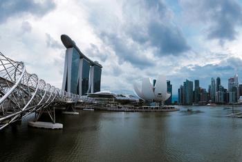 View of the Singapore skyline featuring the Marina Bay Sands hotel, Helix Bridge, and the ArtScience Museum.
