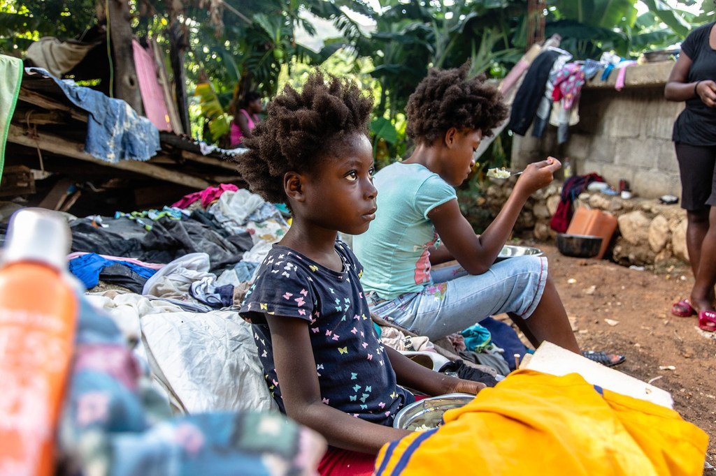 Una familia se sienta en los escombros de su casa destruida tras el terremoto en Haití