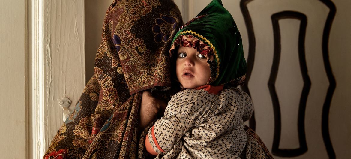 A mother and her child inside a medical clinic in Kandahar, Afghanistan.