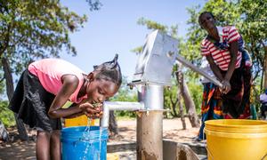 A young girl collects water from a recently rehabiliatitaed well in Gwembe Valley, Zambia