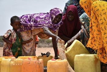 A group of women fetch water at a water trucking point in Kureyson village, Galkayo, Somalia.