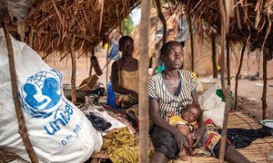 A woman in Tanganyika Province, Democratic Republic of the Congo, poses with her severely malnourished child. 