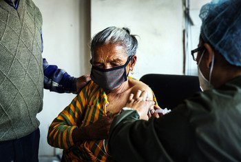 An elderly woman receives a COVID-19 vaccine at Paropakar Maternity and Women’s Hospital in Kathmandu, Nepal.