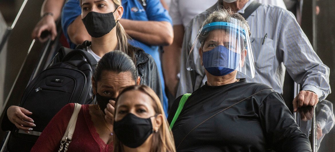 People wear face masks in Medellin, Colombia, to prevent the spread of COVID-19.