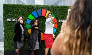 Participants show their support for the Sustainable Development Goals. (file)