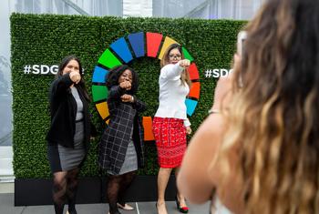Participants show their support for the Sustainable Development Goals. (file)