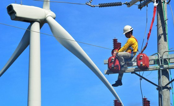 A technician repairs a turbine at a wind farm in the Philippines.