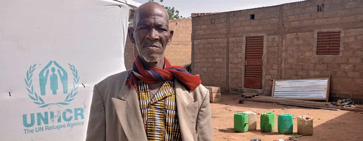 Lambda stands in his compound in the commune of Tougouri, northern Burkina Faso.