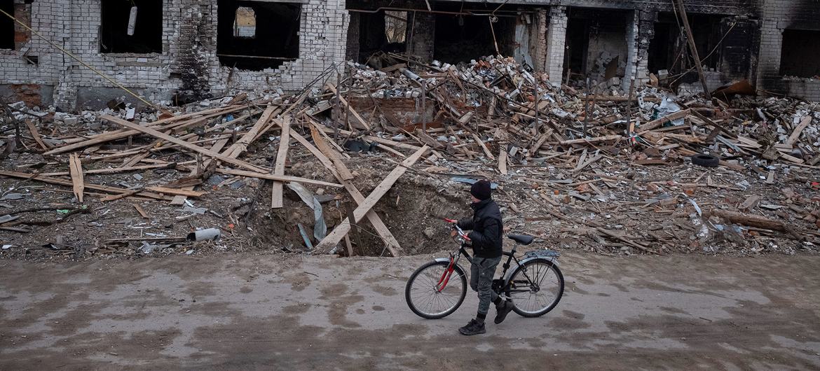 صبي يمشي بالقرب من منازل مدمرة بالقرب من منزله في نوفوسيليفكا، في ضواحي تشيرنيهيف في أوكرانيا.