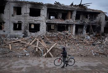 A boy walks past destroyed houses near his home in Novoselivka, on the outskirts of Chernihiv in Ukraine.