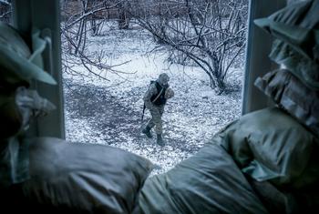 An armed police officer patrols outside a classroom in Donetsk Oblast, Ukraine. (File)
