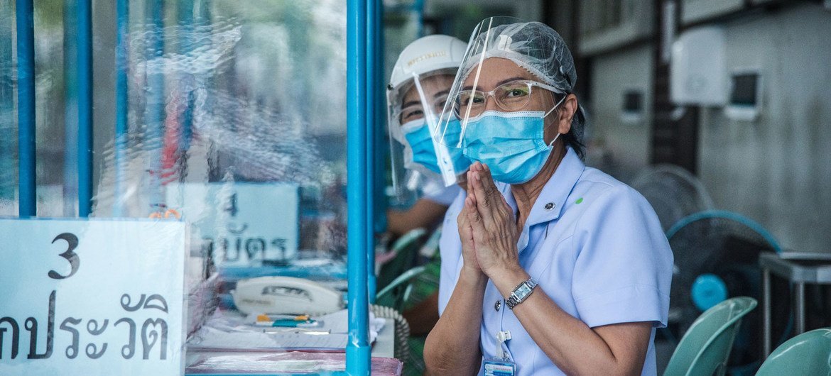 Nurses greet visitors at a clinic set up at a hospital in Thailand to treat people with suspected COVID-19 symptoms.