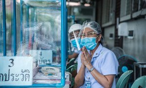 Nurses greet visitors at a clinic set up at a hospital in Thailand to treat people with suspected COVID-19 symptoms.
