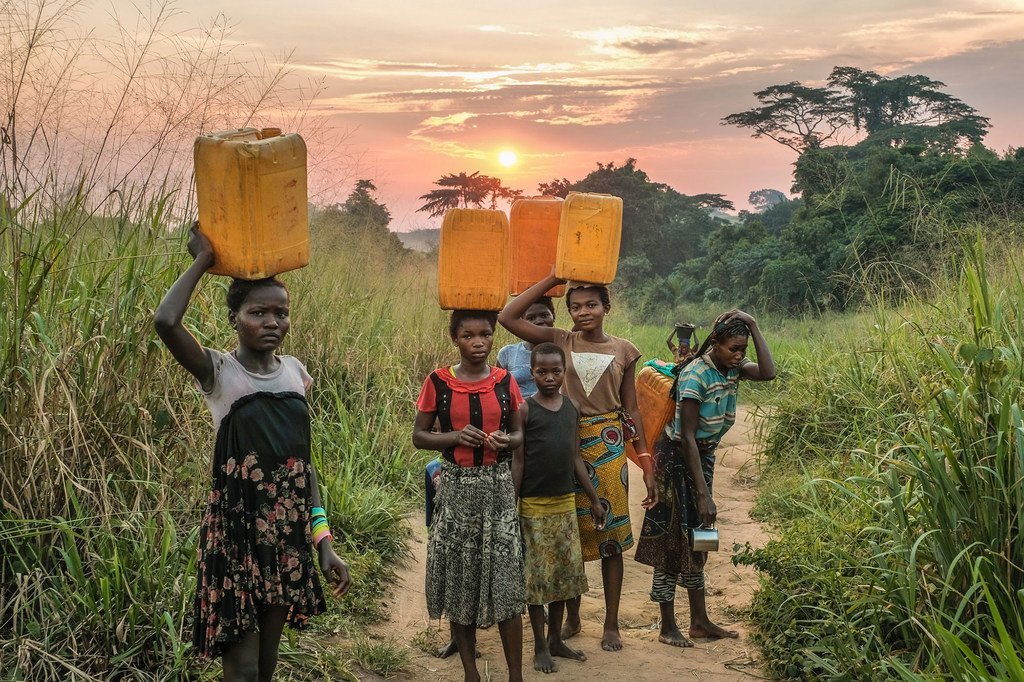 Girls carrying water from a source near Yangambi, Democratic Republic of the Congo.