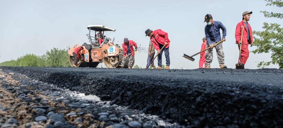 Workers construct a road in Tajikistan.
