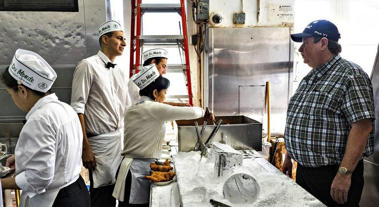 Kenny Swafford (right) talks to his staff in the kitchen of the Café du Monde in New Orleans.