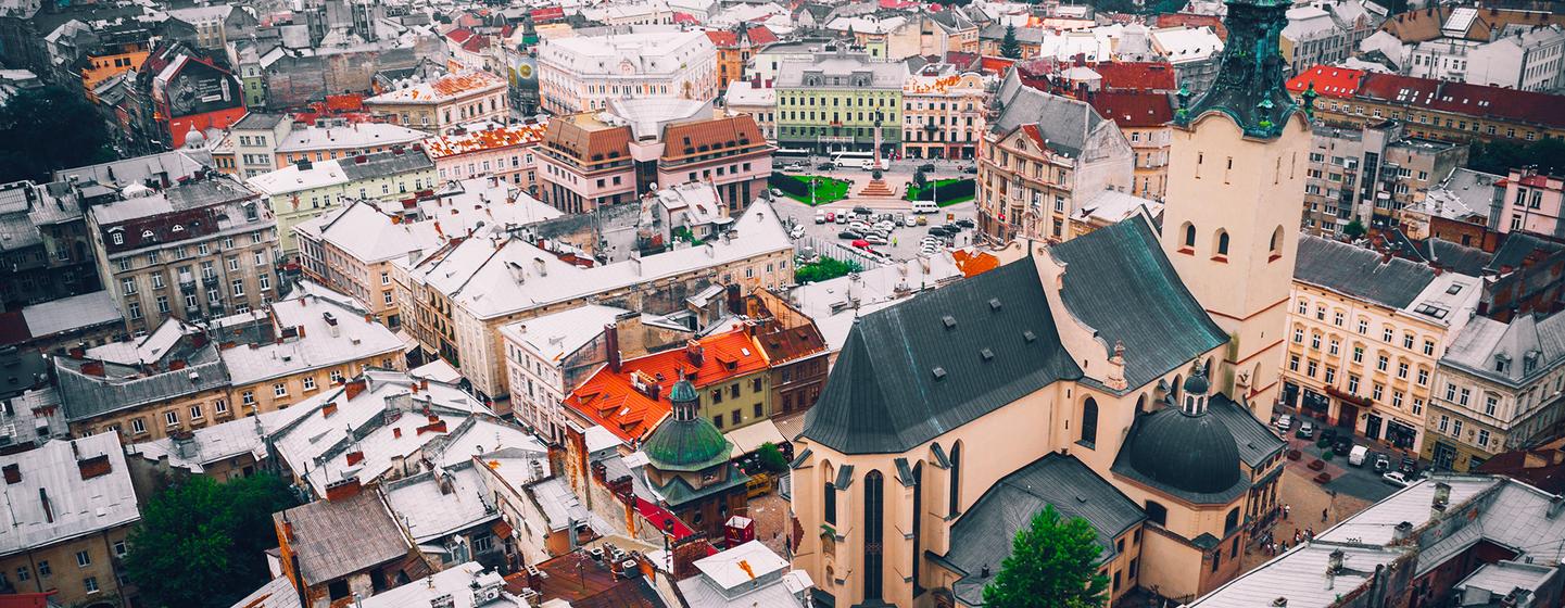 Vue aérienne du centre historique de la ville de Lviv, en Ukraine, mettant en valeur un ensemble dense de bâtiments colorés et de tours d'église saillantes.