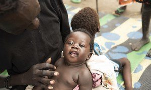 Bathi Kuju is playing with his youngest daughter Gol at a nutrition centre in Pibor, South Sudan